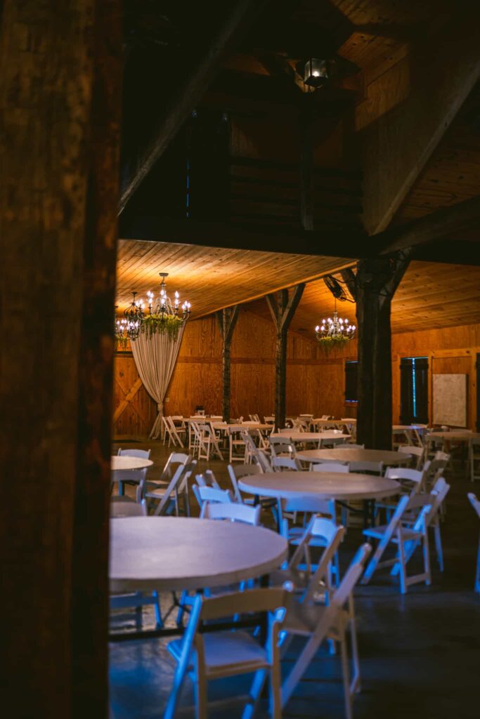 chandelier lights inside wooden barn