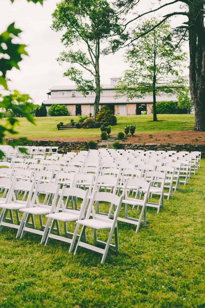 outdoor chairs with barn in background